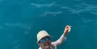 Катето Евро храни риби на Сейшелите